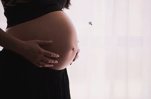 a pregnant woman showing her stomach
