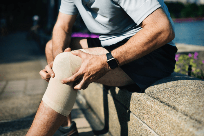 a person holding his knee