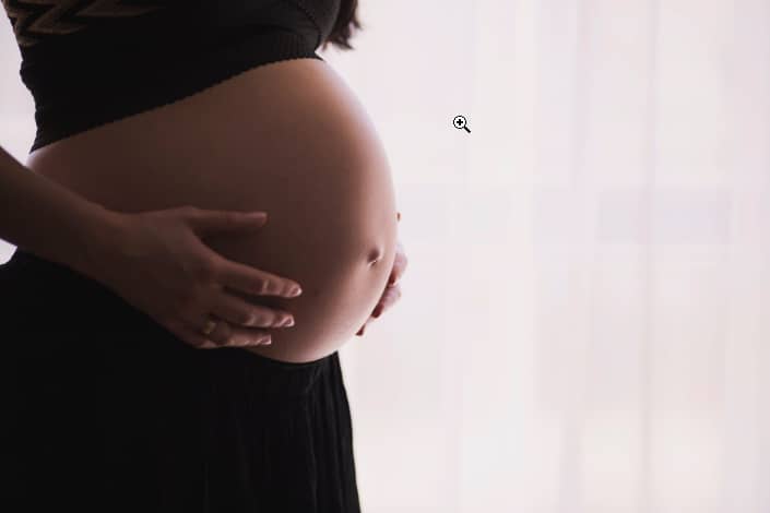 a pregnant woman showing her stomach