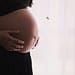 a pregnant woman showing her stomach